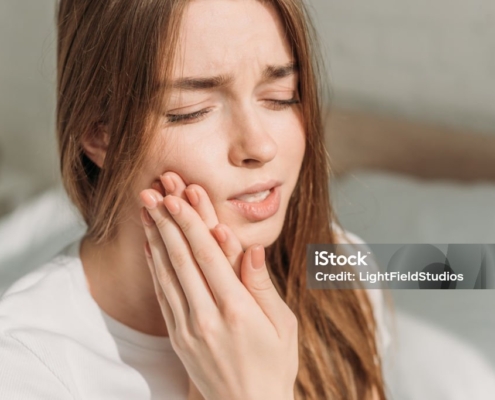 Young Woman Touching Cheek While Suffering From Toothache
